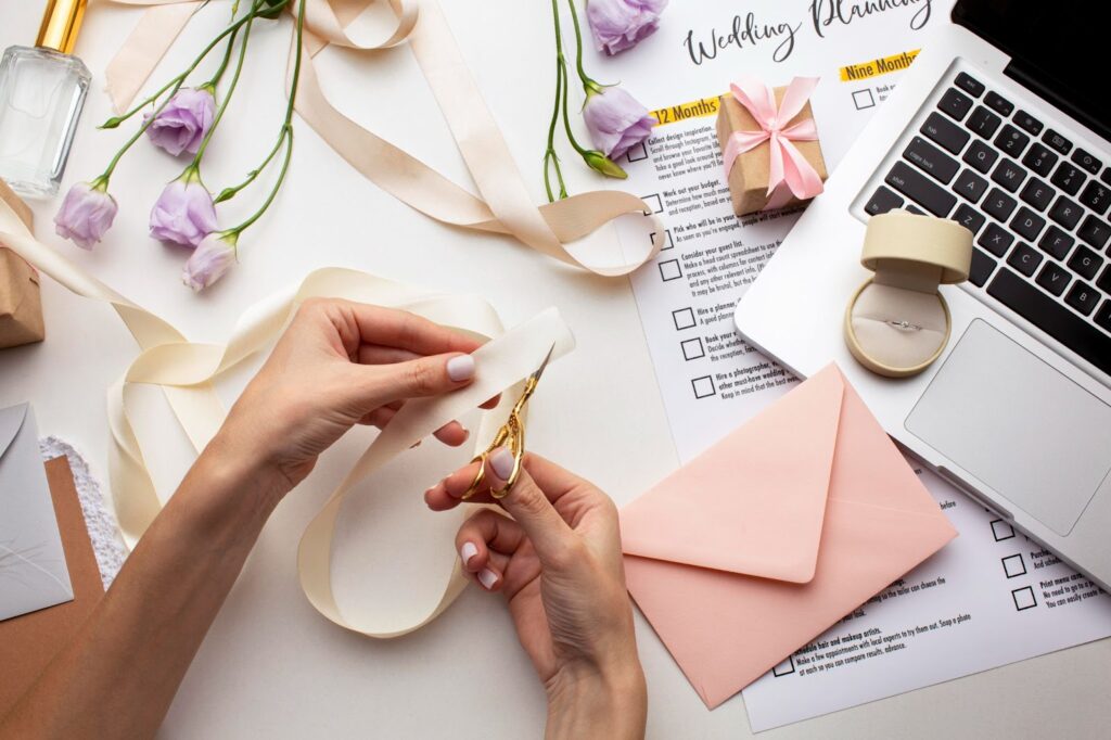 Top view of hands creating handmade invitations