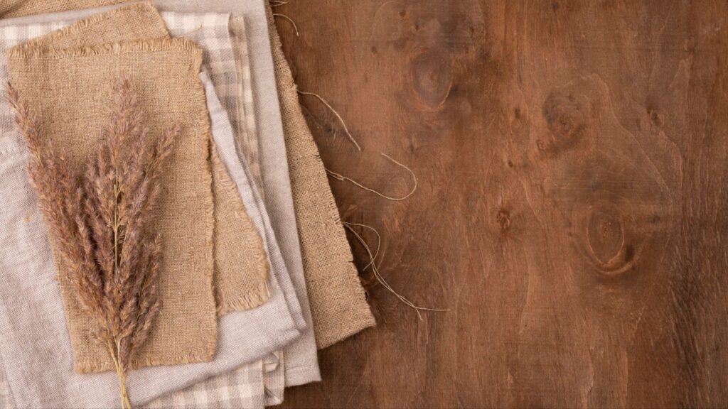 Top view of monochromatic selection of textiles with dried grass