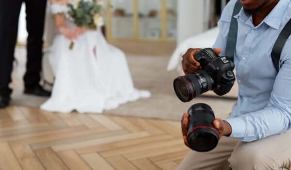 Side view photographer holding camera